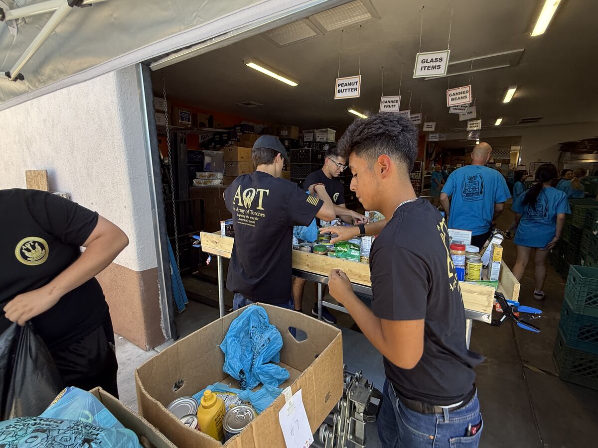 AOT volunteers sorting canned goods and dry staples inside the food bank warehouse