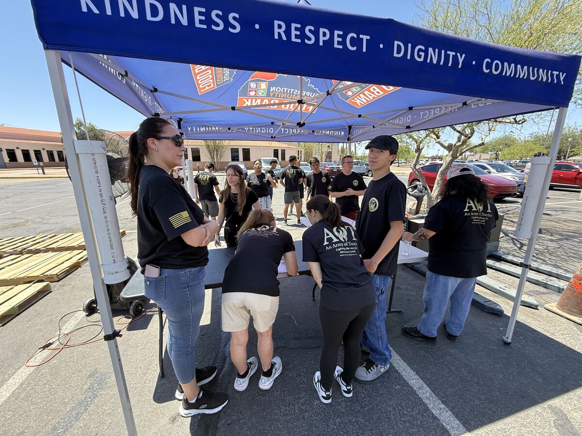 AOT volunteers signing in and preparing for the food drive under the Superstition Food Bank canopy