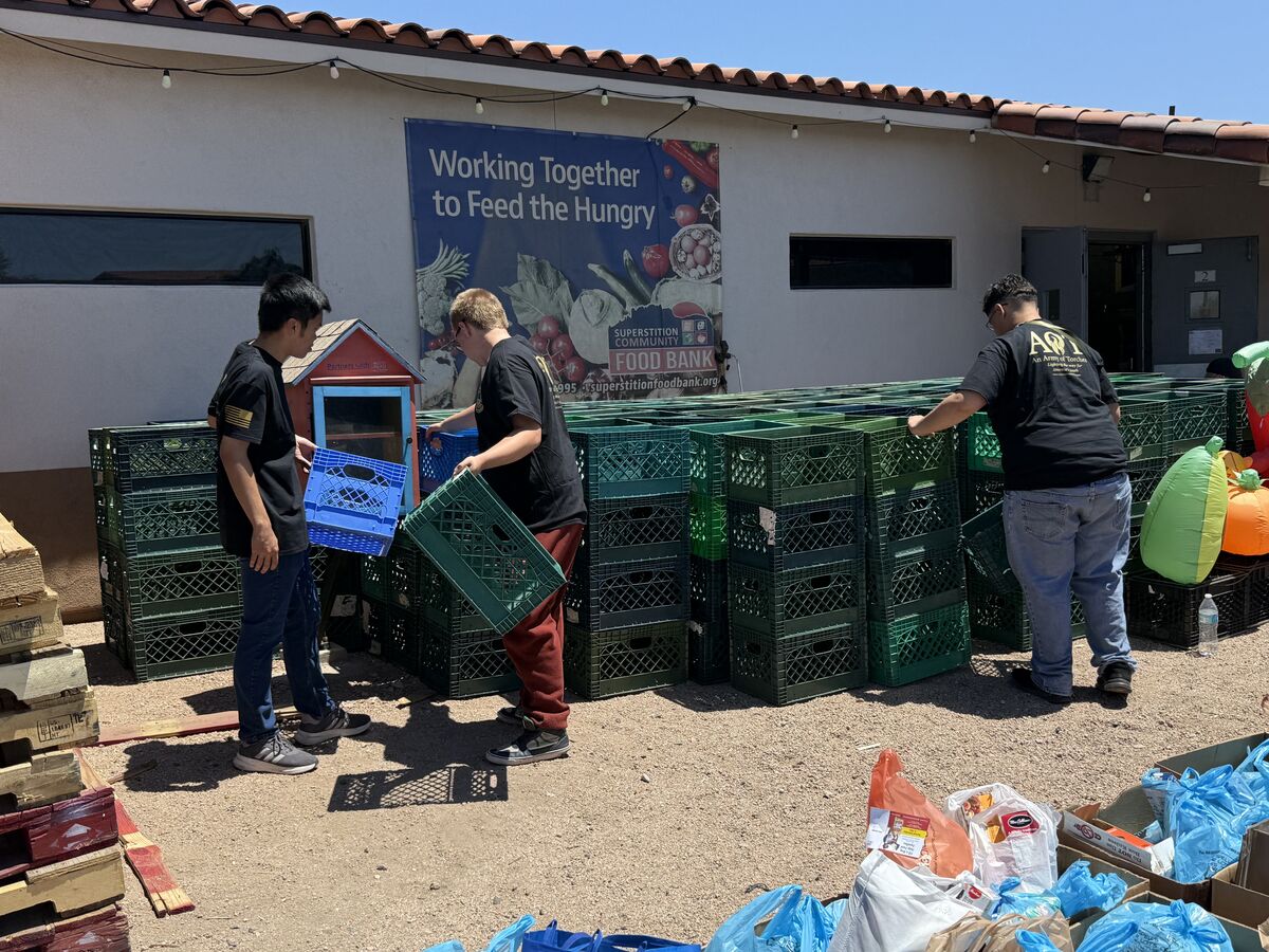 AOT youth stacking green produce crates at the Superstition Community Food Bank