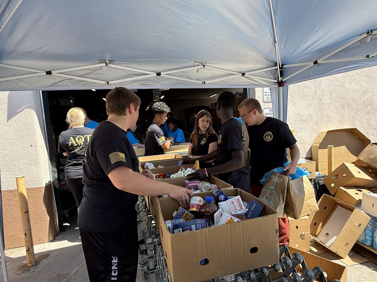 AOT members sorting boxes of food near the warehouse loading dock entrance