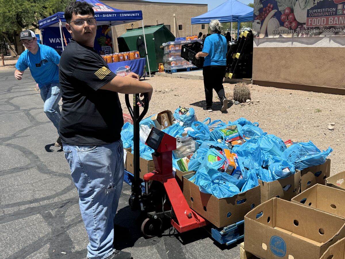 AOT volunteer weighing boxes of food donations on a pallet jack at the Superstition Food Bank